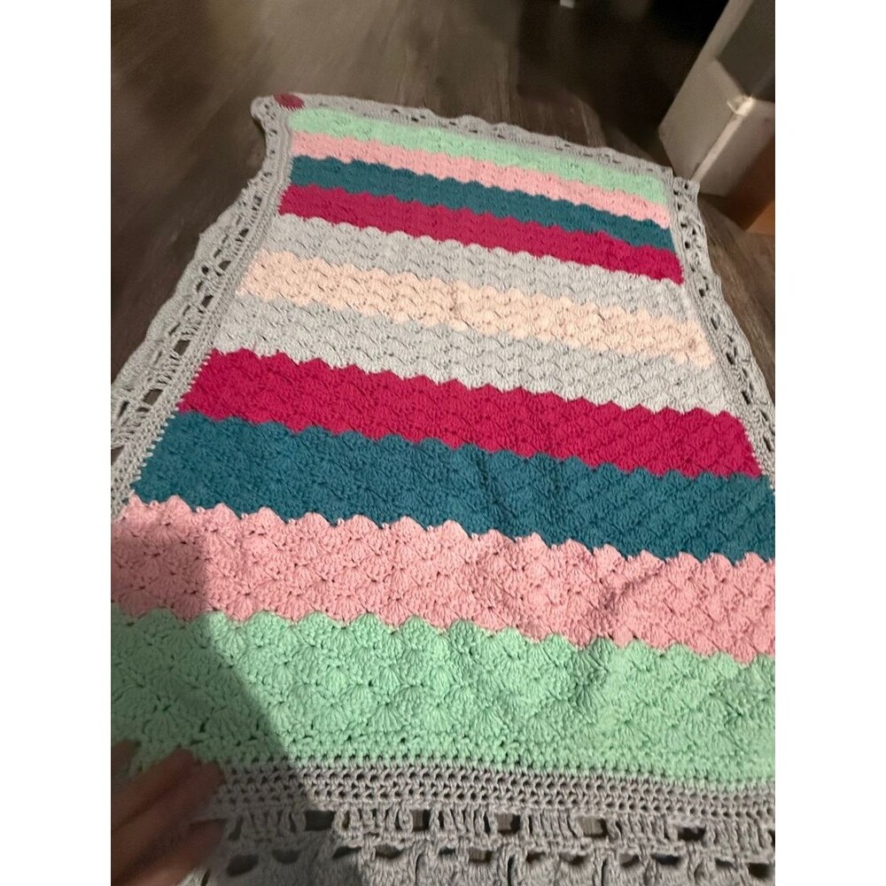 Handmade baby blanket signed by crafter with logo